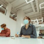 Caucasian woman attentively listening to teacher at university
