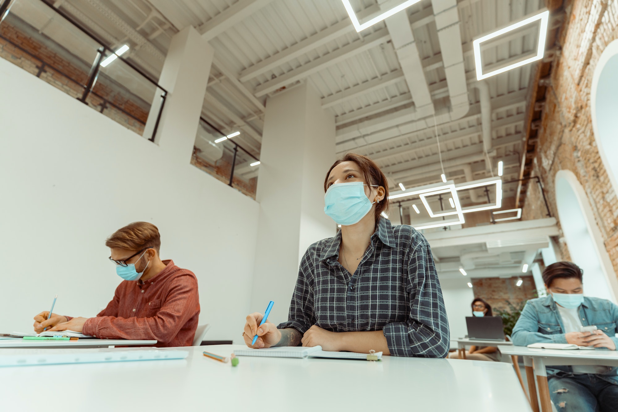 Caucasian woman attentively listening to teacher at university