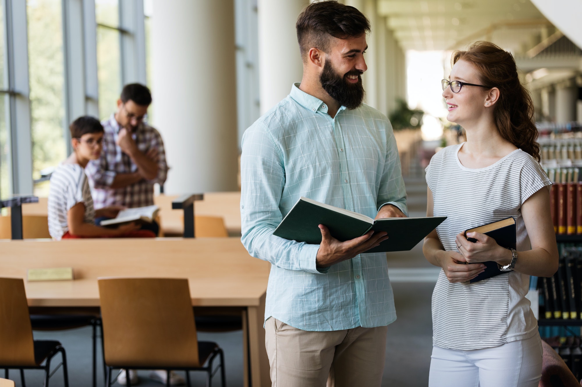 Group of college students studying at library