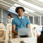 Mixed race guy talking to university teacher