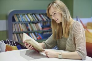 Reading at the table in the library